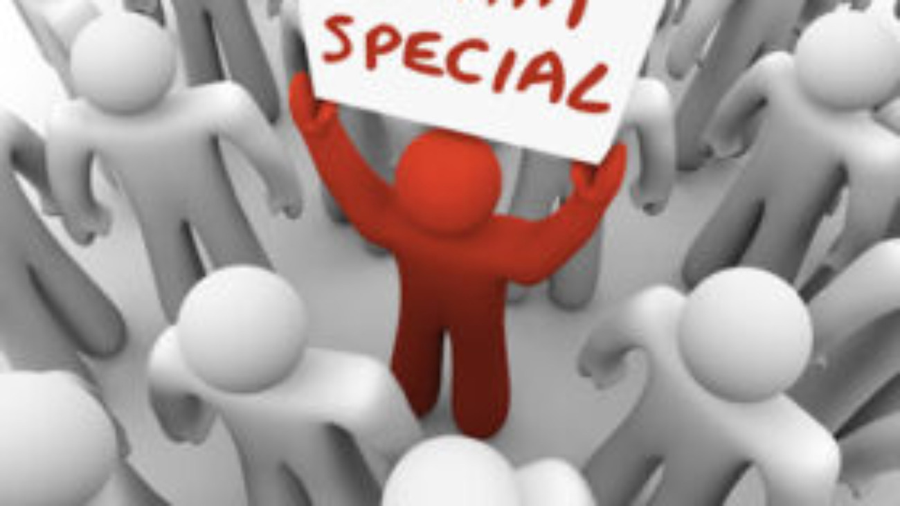 I Am Special words on a sign held by a man in a crowd standing out as different, unique, exceptional, rare or uncommon as the best choice to hire for a job, choose for an assignment or pick for a task